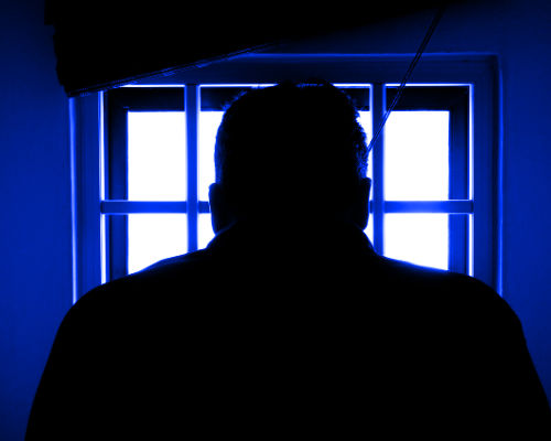 Silhouette of man in prison